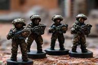 Detailed painted miniature figures on a war gaming tabletop
